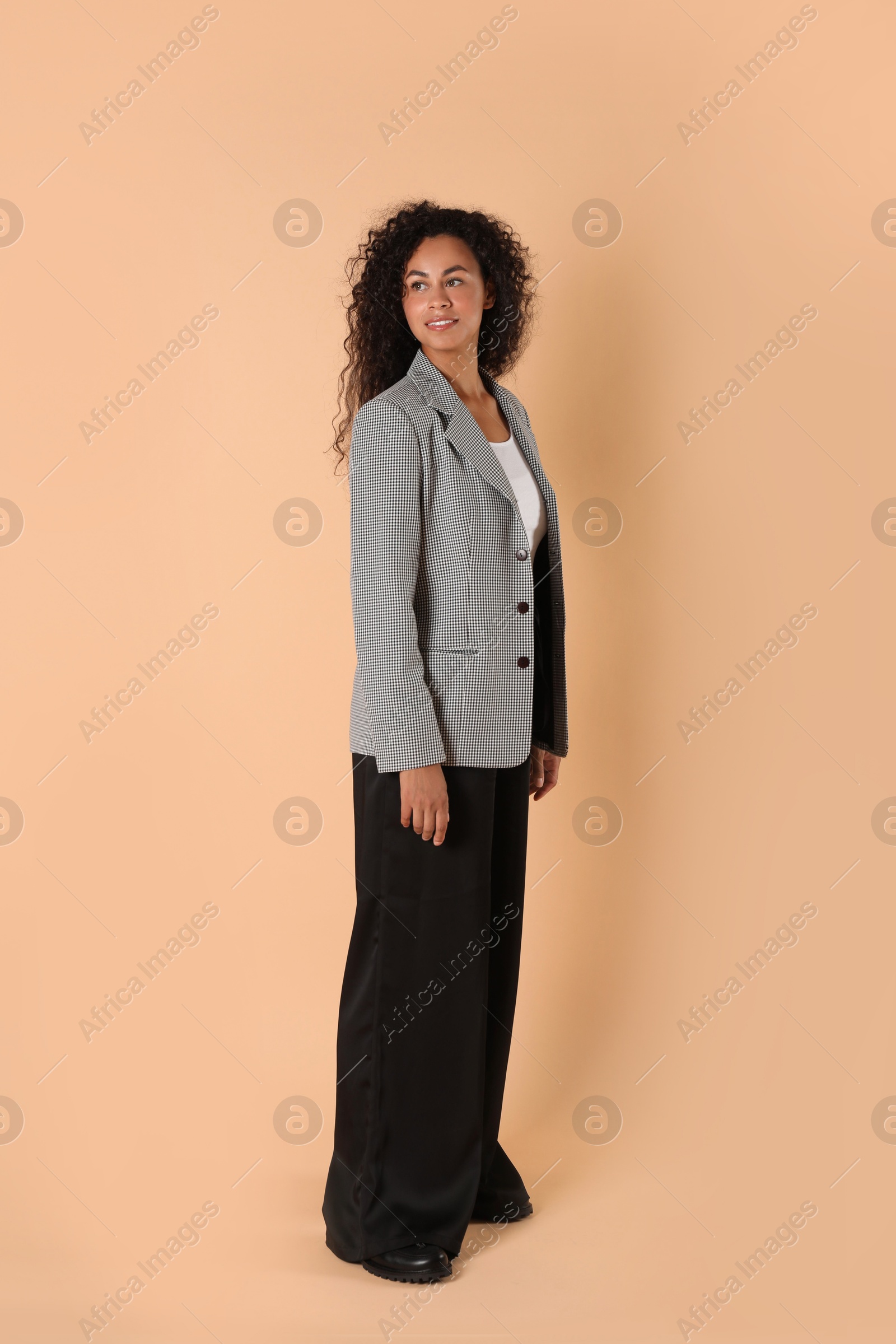 Photo of Beautiful woman in stylish jacket on beige background