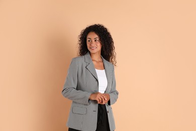 Photo of Beautiful woman in stylish jacket on beige background