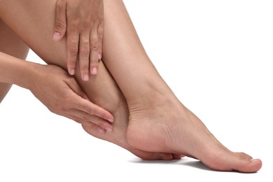 Photo of Woman touching her smooth feet on white background, closeup