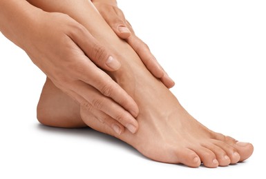 Photo of Woman touching her smooth feet on white background, closeup