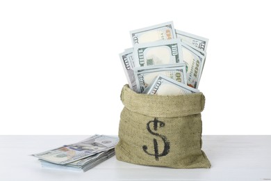 Photo of Dollar banknotes in bag on table against white background