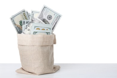 Dollar banknotes in bag on table against white background, space for text