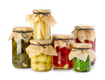 Photo of Different pickled products in jars isolated on white