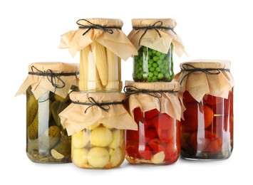 Photo of Different pickled products in jars isolated on white