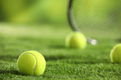 Photo of Tennis ball on green grass, closeup. Space for text