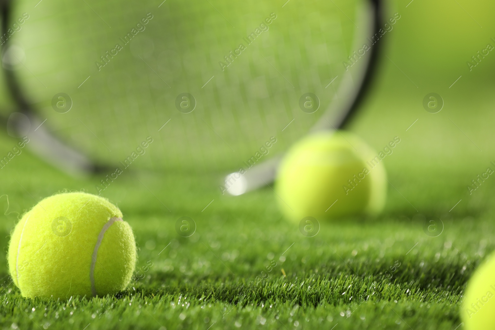 Photo of Tennis balls on green grass, closeup view