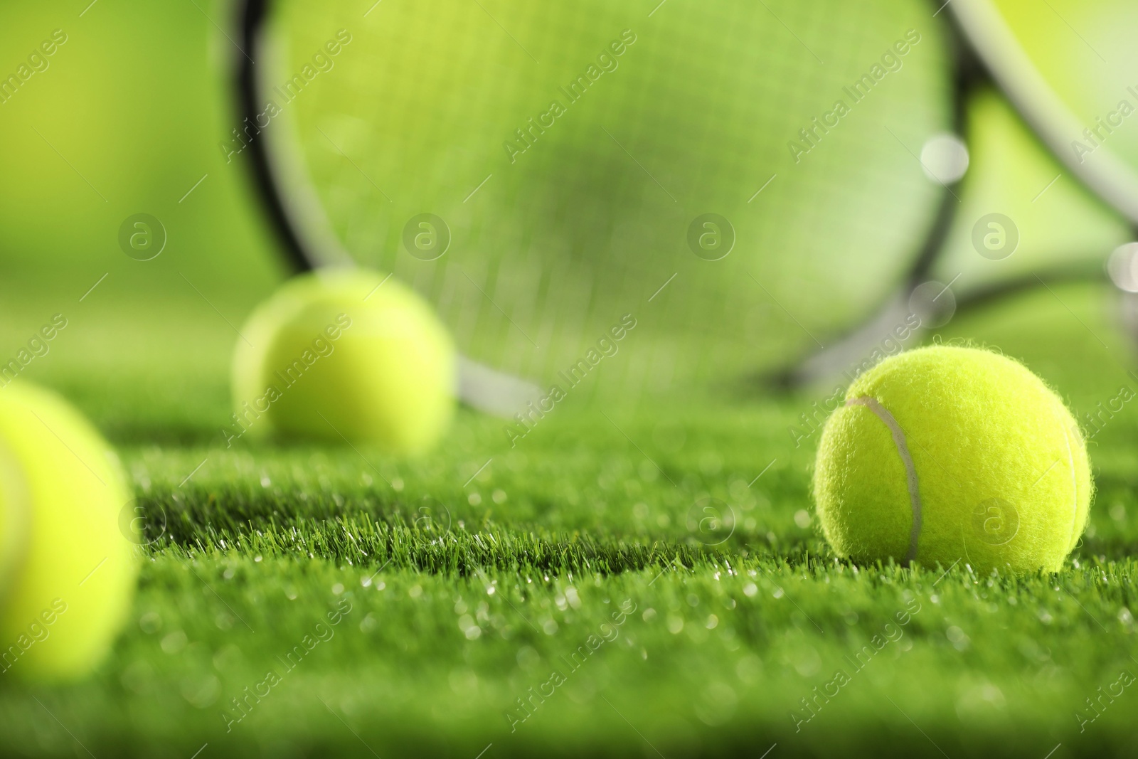 Photo of Tennis balls on green grass, closeup view