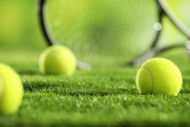 Photo of Tennis balls on green grass, closeup view