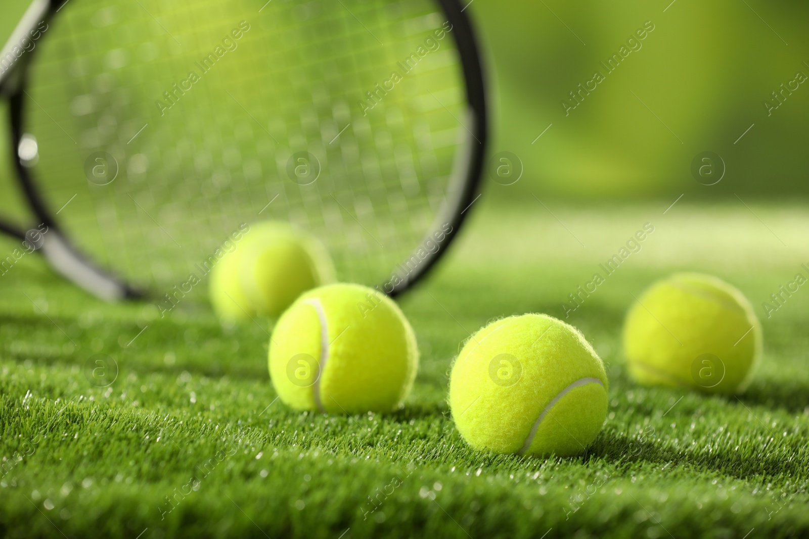 Photo of Tennis balls on green grass, closeup view