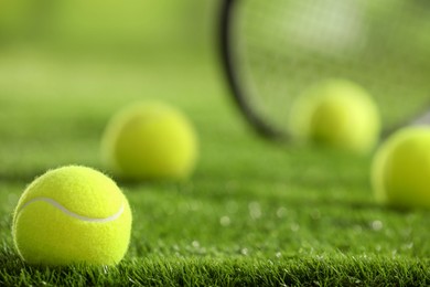 Photo of Tennis ball on green grass, closeup. Space for text