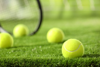 Photo of Tennis ball on green grass, closeup. Space for text