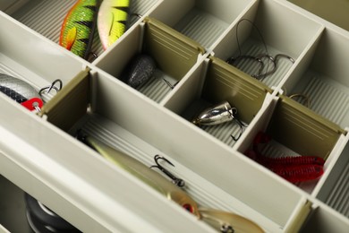 Photo of Different fishing tackles in box, closeup view