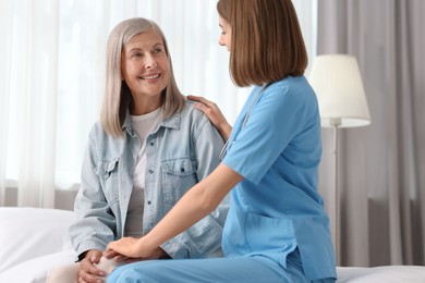 Healthcare worker supporting senior patient at home