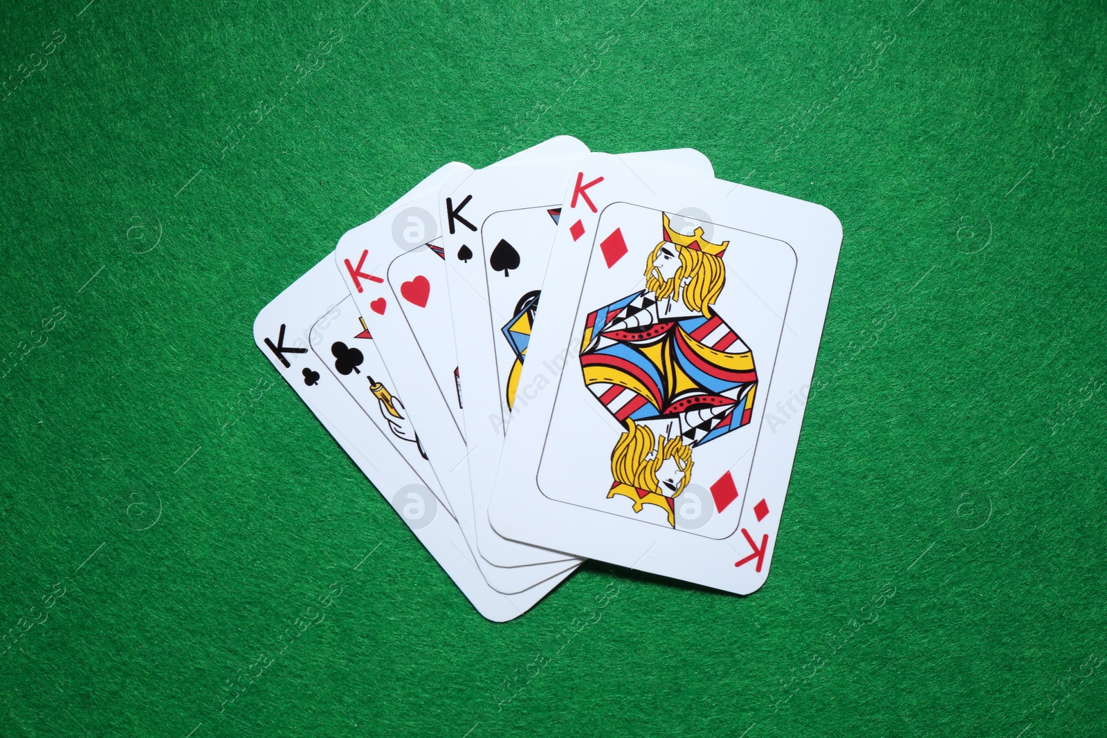 Photo of Poker game. Playing cards on green table, flat lay