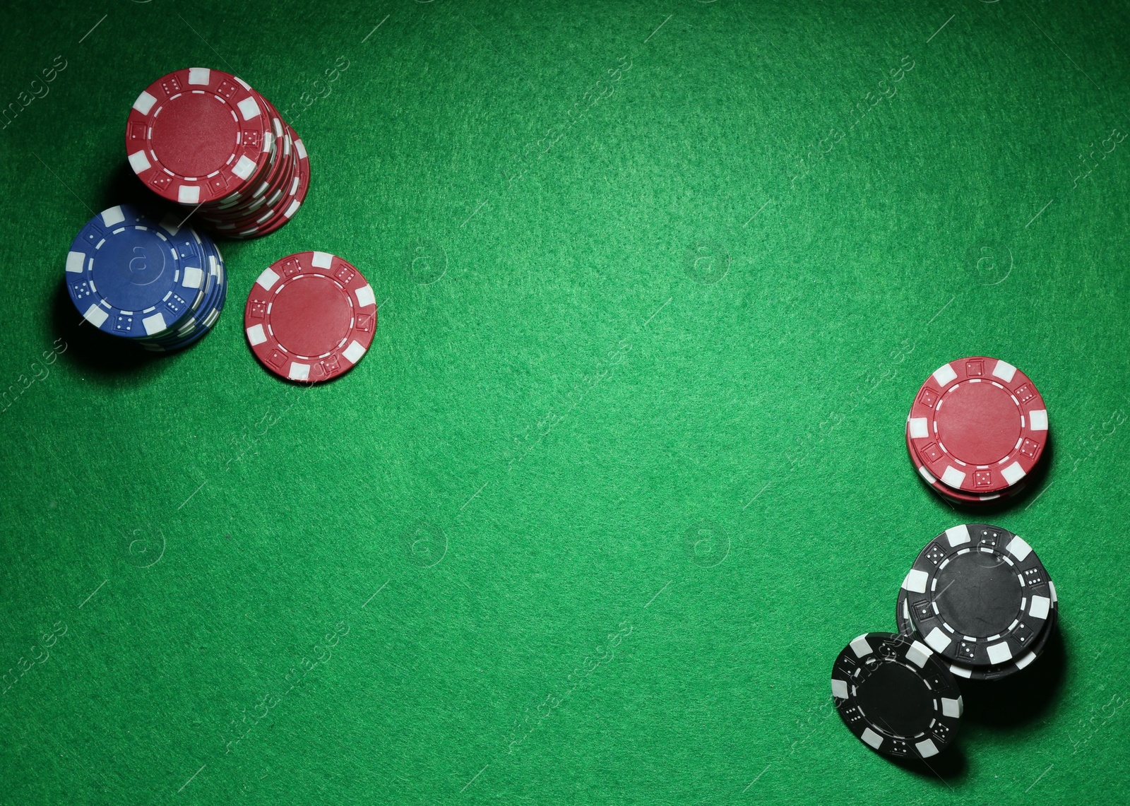 Photo of Poker chips on green table, flat lay. Space for text