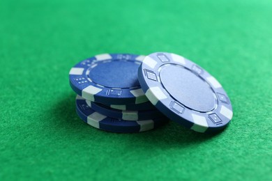 Group of poker chips on green table, closeup