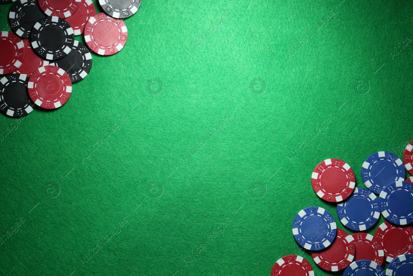 Photo of Poker chips on green table, flat lay. Space for text