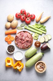 Photo of Cooking stew. Uncooked meat and vegetables on light grey table, flat lay