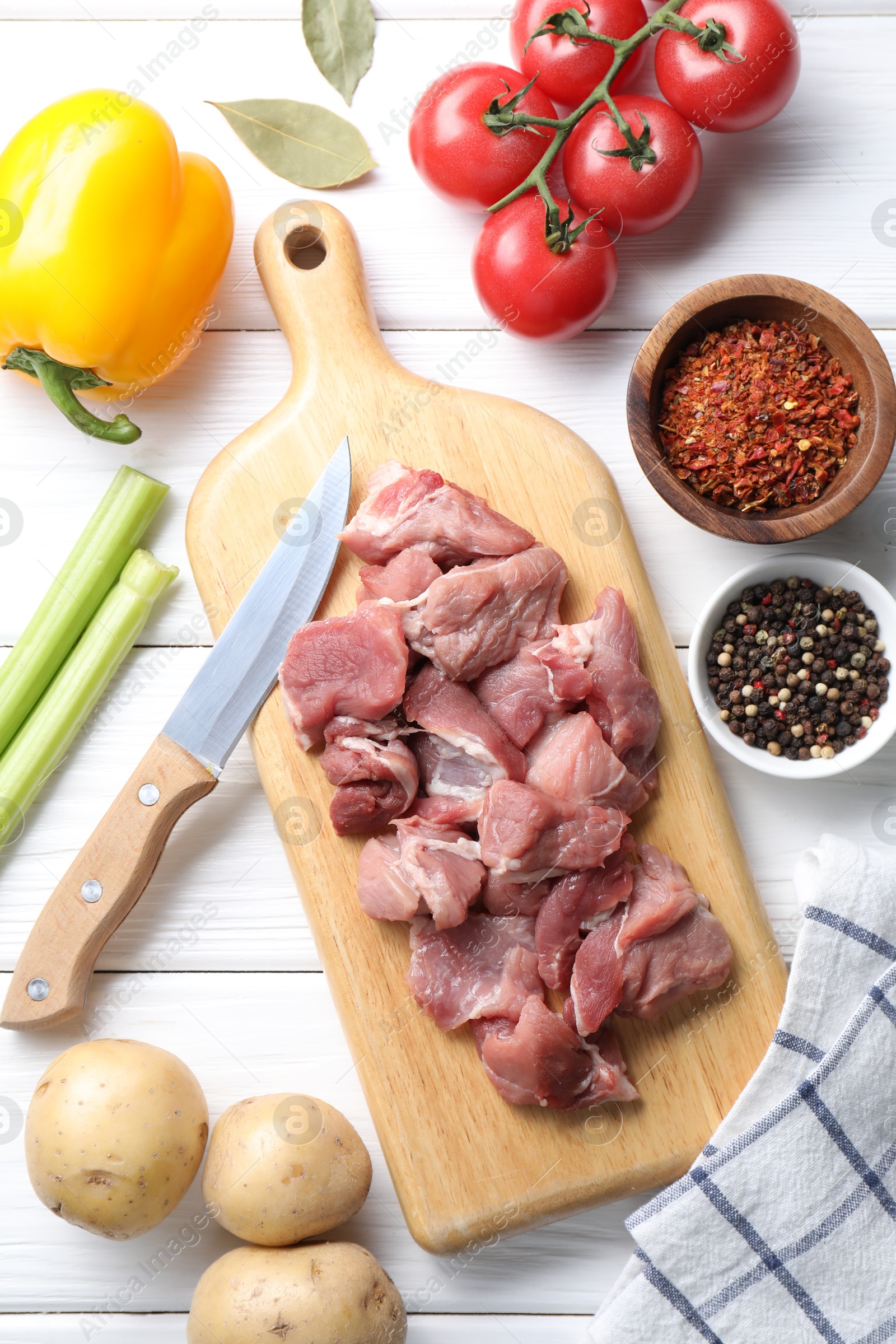 Photo of Cooking stew. Uncooked meat and vegetables on white wooden table, flat lay