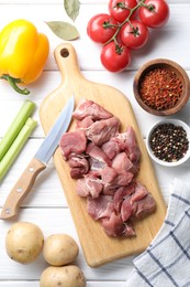 Photo of Cooking stew. Uncooked meat and vegetables on white wooden table, flat lay