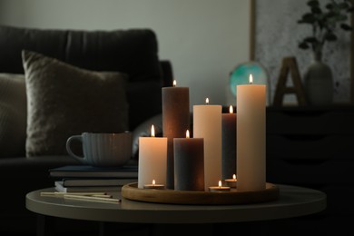 Beautiful burning candles and matches on table indoors