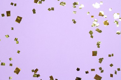 Frame of shiny confetti on violet background, flat lay. Space for text