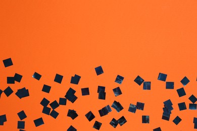 Shiny confetti on orange background, top view. Space for text