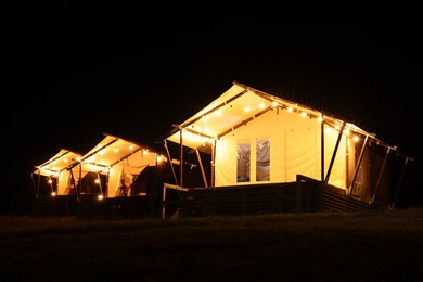 Tents in mountains at night. Glamping site