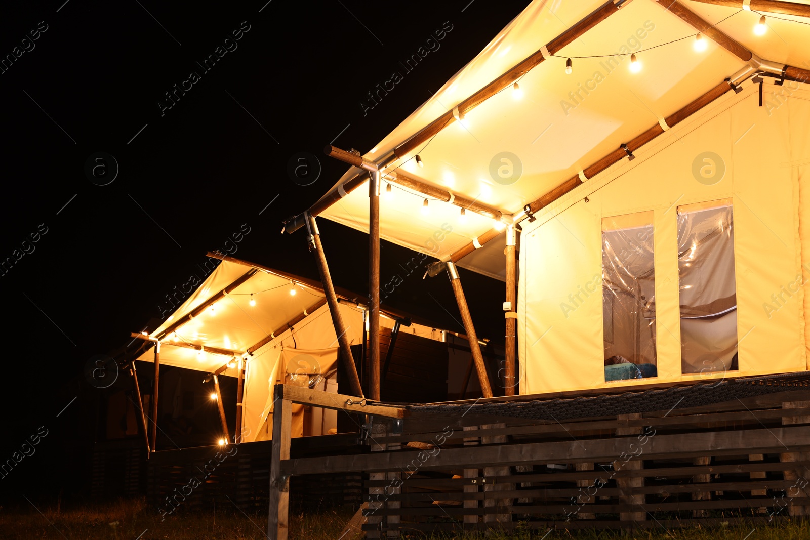 Photo of Tents in mountains at night. Glamping site