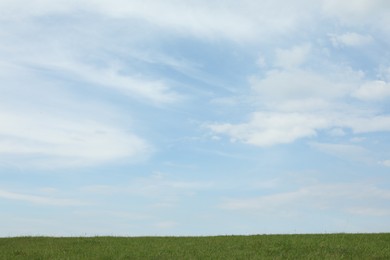 Photo of Picturesque view of field and sky with fluffy clouds