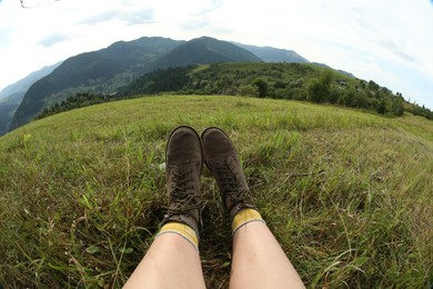 Photo of Young hiker in mountains, closeup. Fisheye lens effect