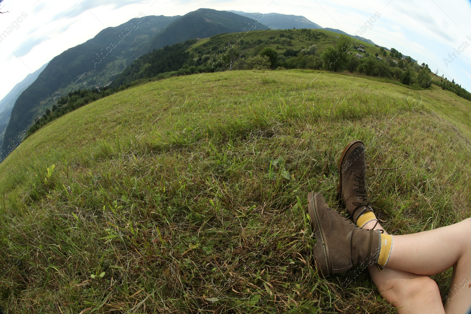 Photo of Young hiker in mountains, closeup and space for text. Fisheye lens effect