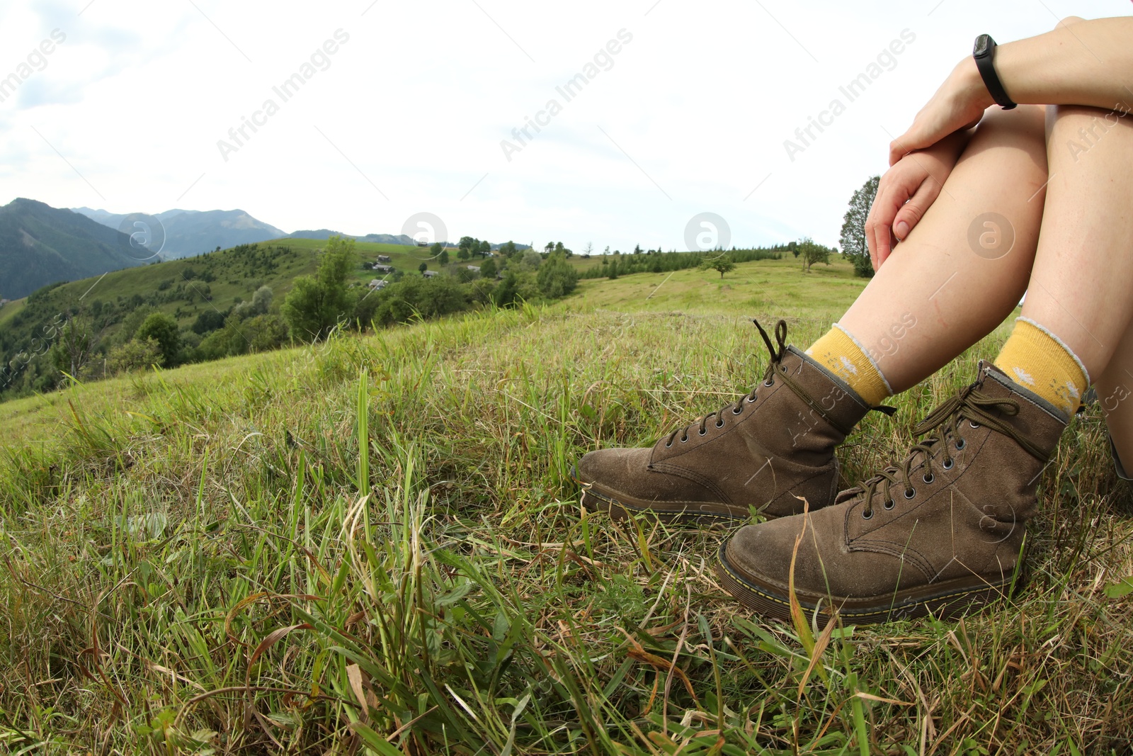 Photo of Young hiker in mountains, closeup and space for text. Fisheye lens effect