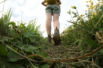 Photo of Young hiker in field, closeup. Fisheye lens effect