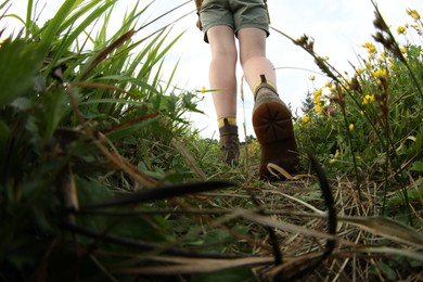 Young hiker in field, closeup. Fisheye lens effect