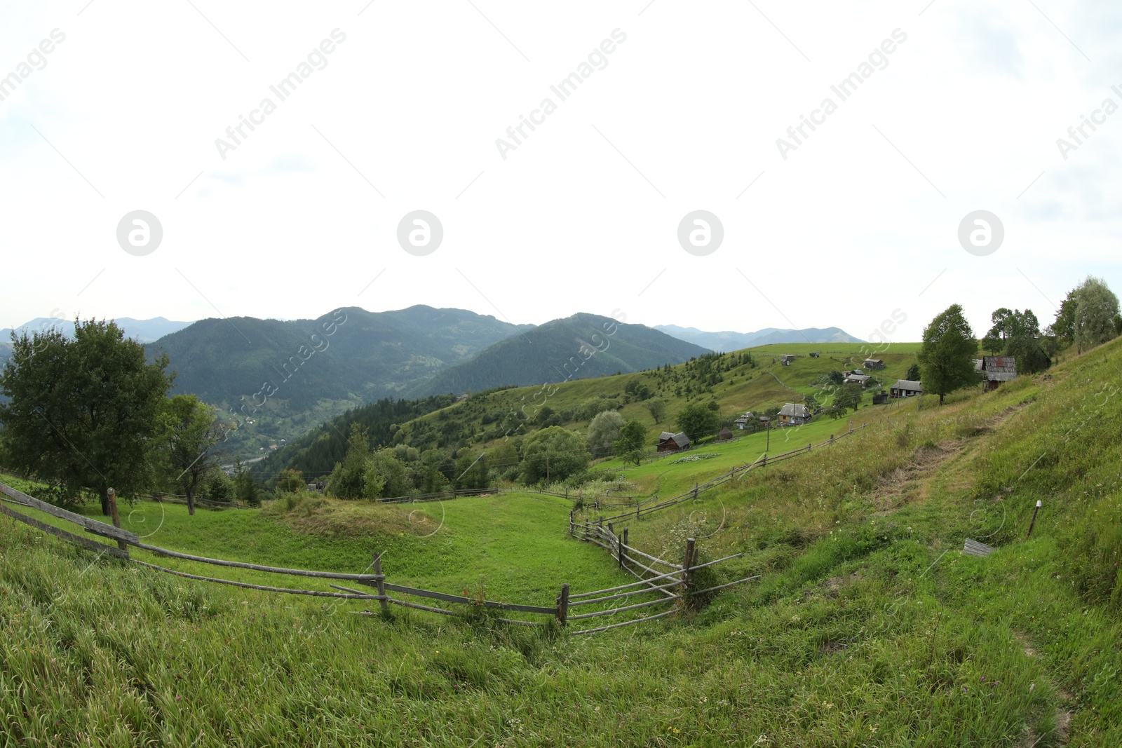 Photo of Beautiful view of wooden fence in mountains under sky