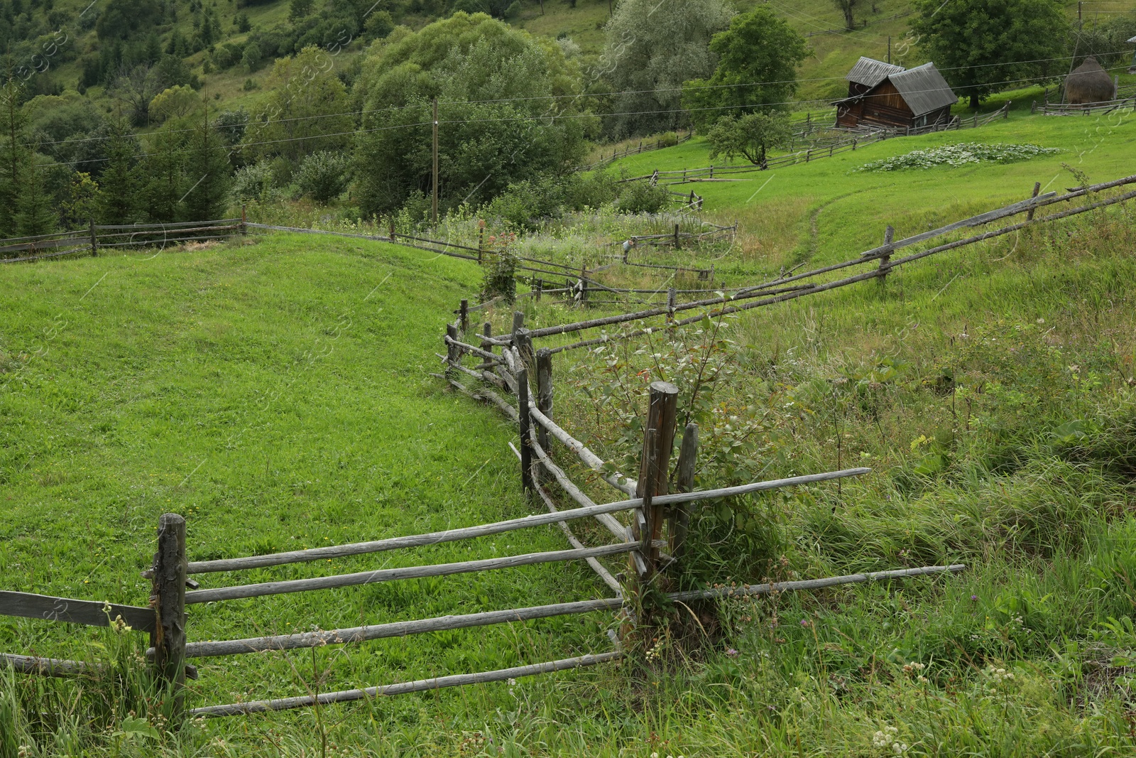 Photo of Beautiful view of wooden fence in mountains under sky