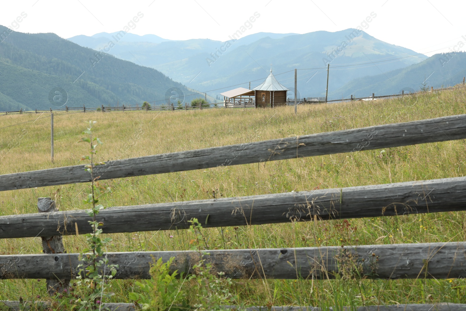 Photo of Beautiful view of wooden fence in mountains under sky