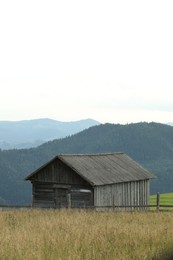 Photo of Beautiful view of forest and building in mountains under sky