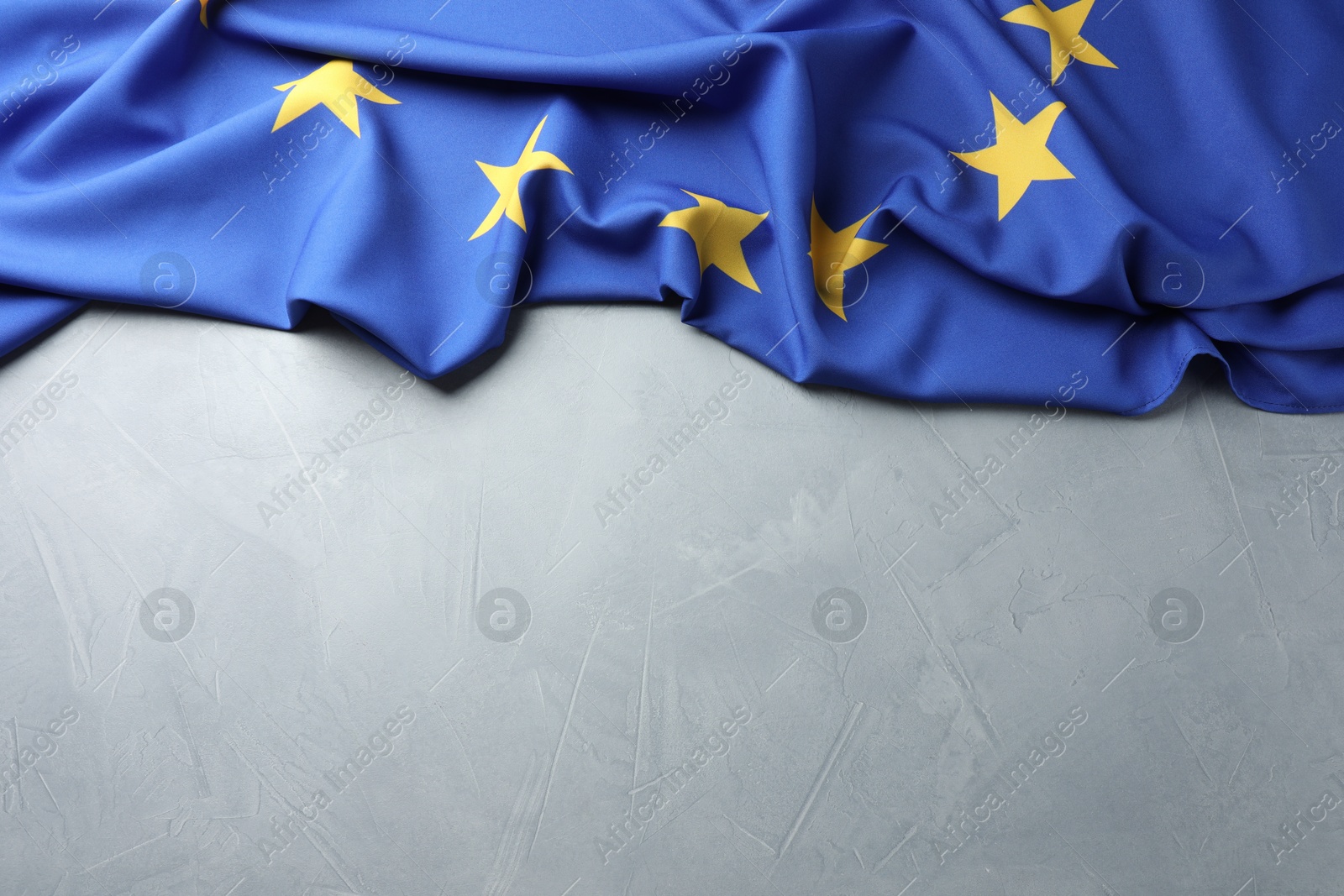 Photo of Flag of European Union on light grey table, above view