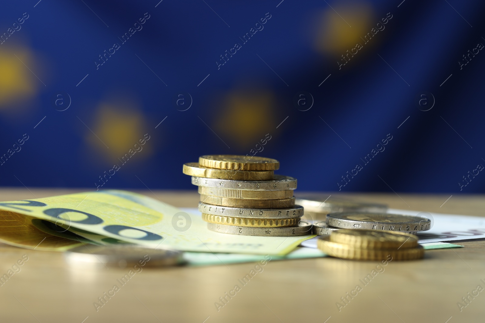 Photo of Euro banknotes and coins on table, closeup