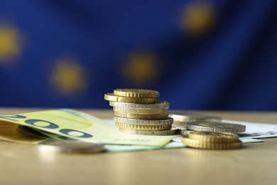 Photo of Euro banknotes and coins on table, closeup