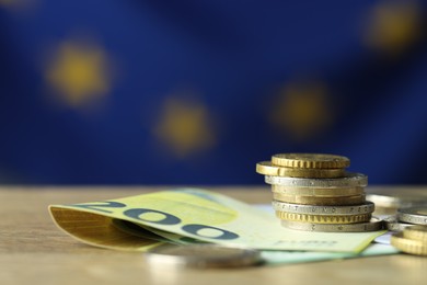 Photo of Euro banknotes and coins on table, closeup