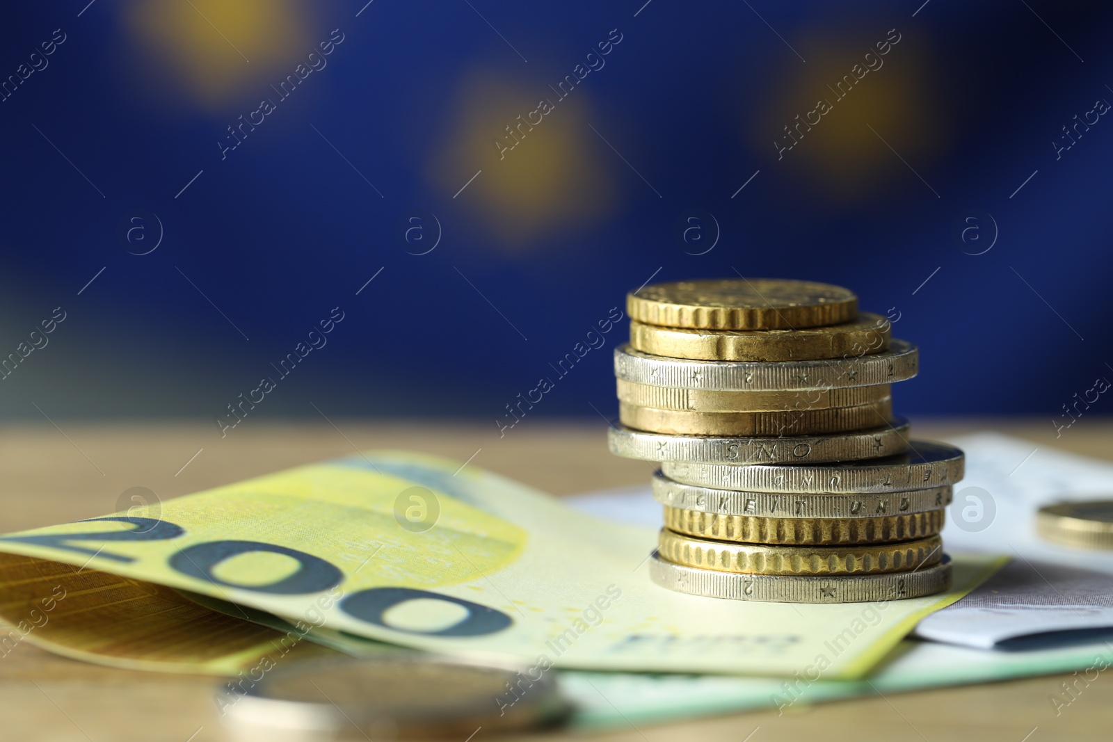 Photo of Euro banknotes and coins on table, closeup