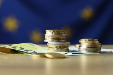 Photo of Euro banknotes and coins on table, closeup