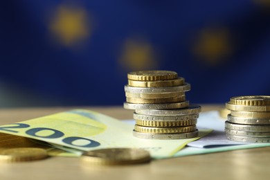 Photo of Euro banknotes and coins on table, closeup