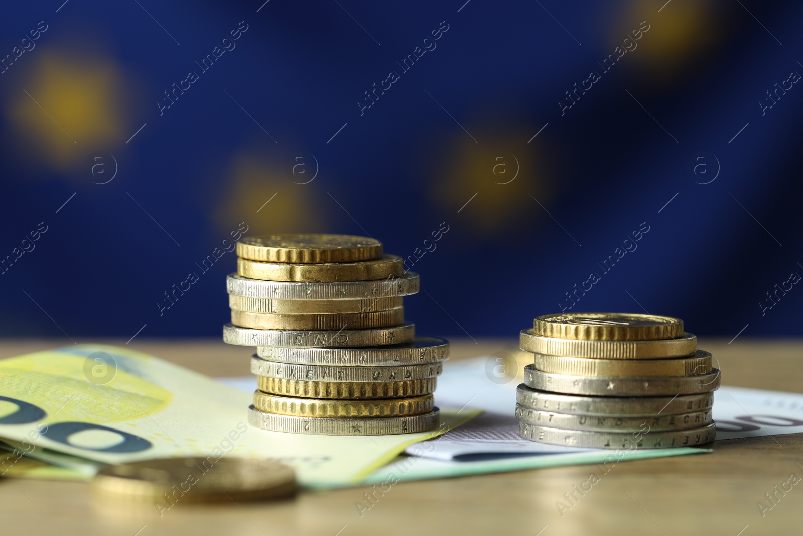 Photo of Euro banknotes and coins on table, closeup