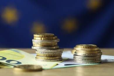 Photo of Euro banknotes and coins on table, closeup