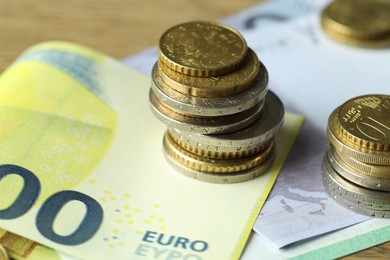 Photo of Euro banknotes and coins on table, closeup