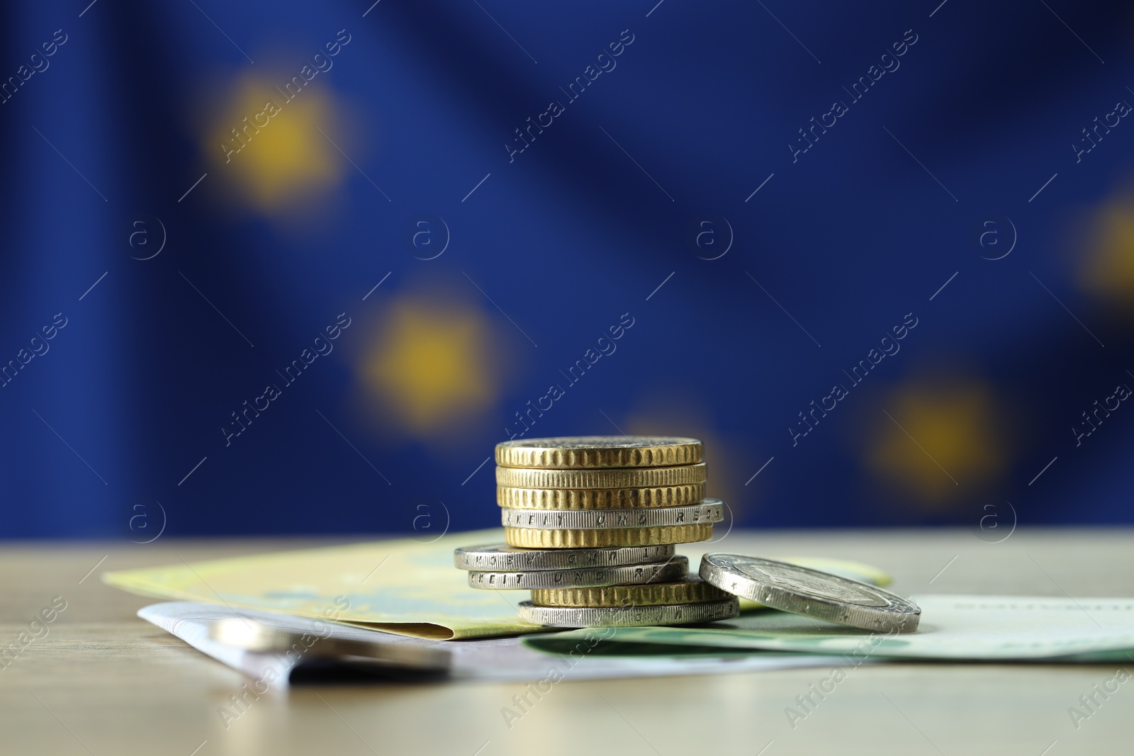 Photo of Coins and euro banknotes on table, closeup